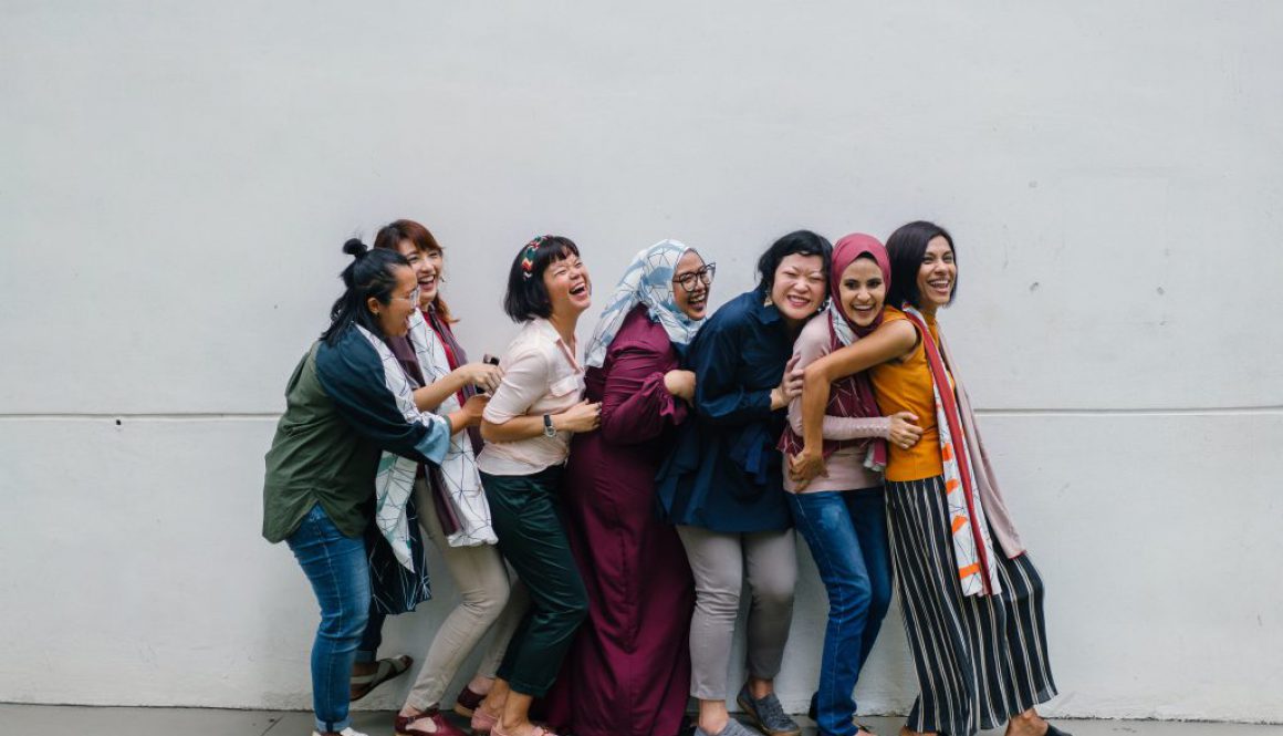 Group of women standing together and embracing