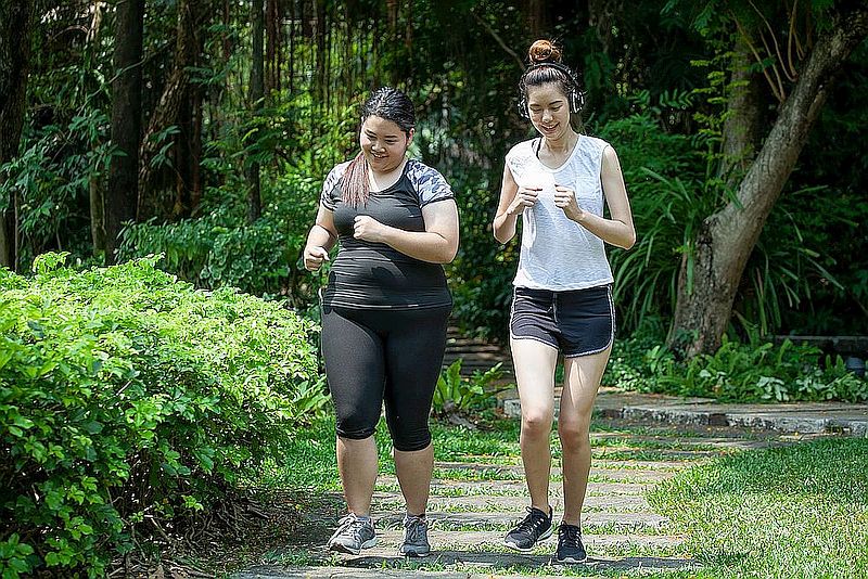 Asian Thin and overweight woman jogging in park, fat and fitness